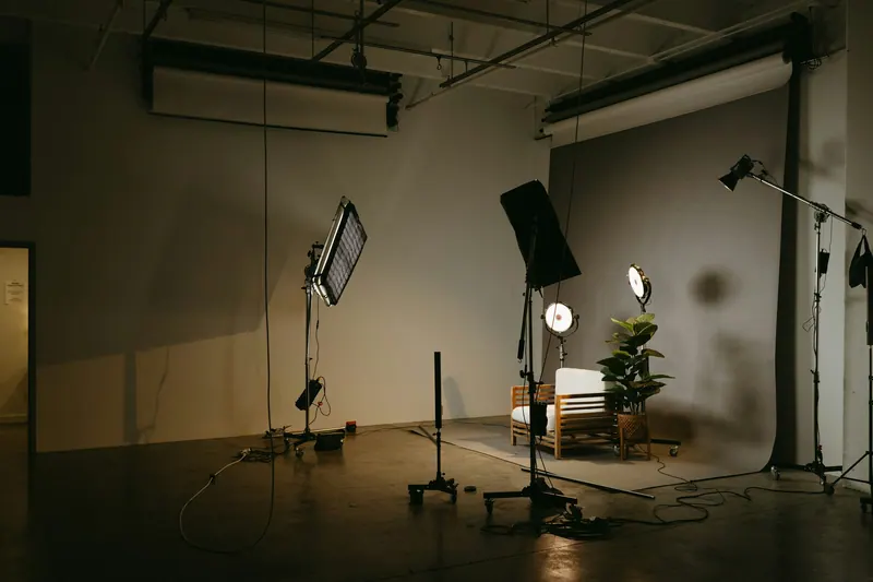 Photography studio with softboxes, stands and a seamless backdrop, studio lighting setup