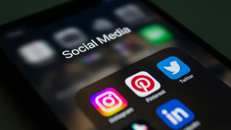 Smartphone screen showing Instagram, Pinterest and LinkedIn icons, social media video content