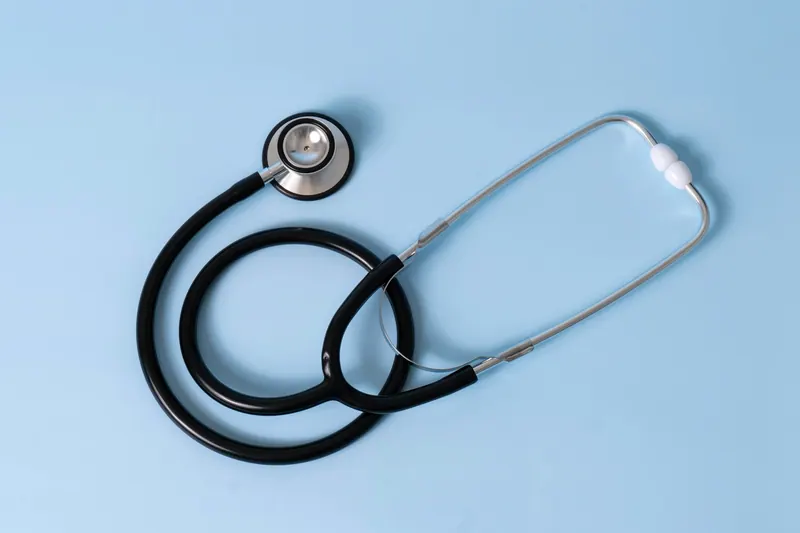 Stethoscope on a flat blue background, clean healthcare photography