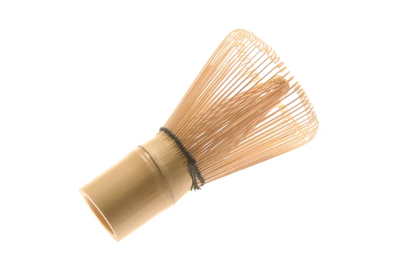 Bamboo matcha whisk chasen with fine tines on a white background, lifestyle product photography