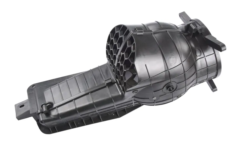 Black moulded plastic air duct component with honeycomb outlet, industrial component photography