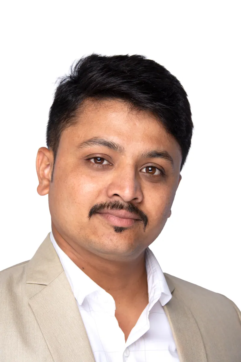 Businessman with a moustache wearing a beige blazer, professional corporate headshot against white