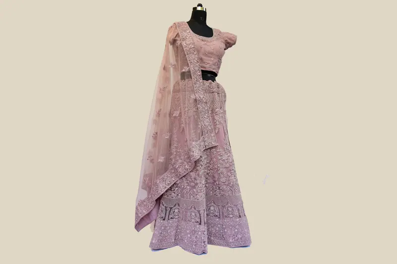 Lavender embroidered lehenga with net dupatta on a mannequin against beige, apparel e-commerce photography in Pune