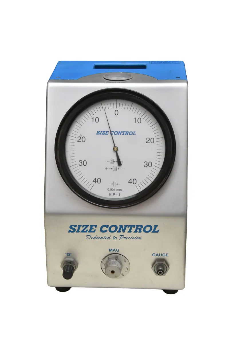 Size control air gauge instrument with a round dial on a clean white background, catalogue photography for a precision measuring manufacturer