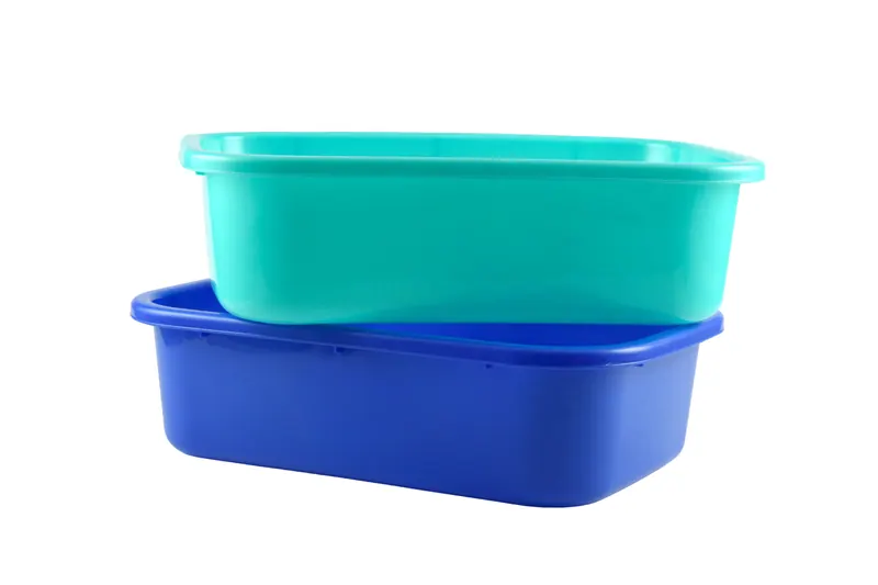 Teal and blue moulded plastic tubs stacked on a white background, household product photography
