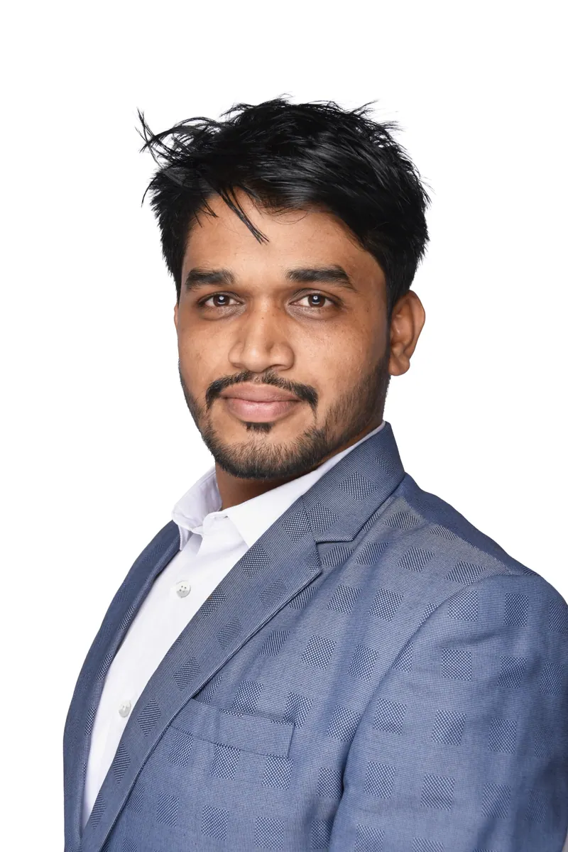 Young professional with swept hair in a blue blazer, corporate headshot photographed in Pune